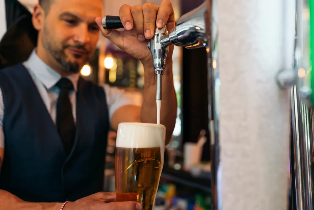barman serving beer in a pub 2024 10 12 01 14 12 utc