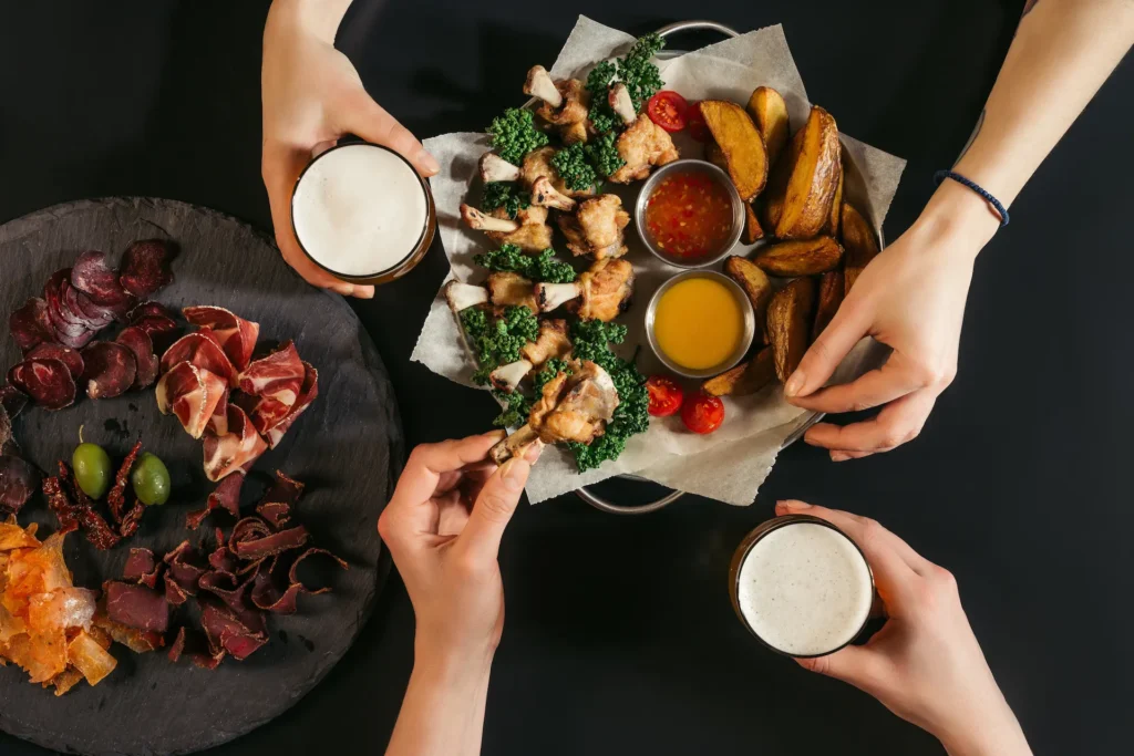 cropped shot of people drinking beer and eating de 2024 11 17 19 03 08 utc